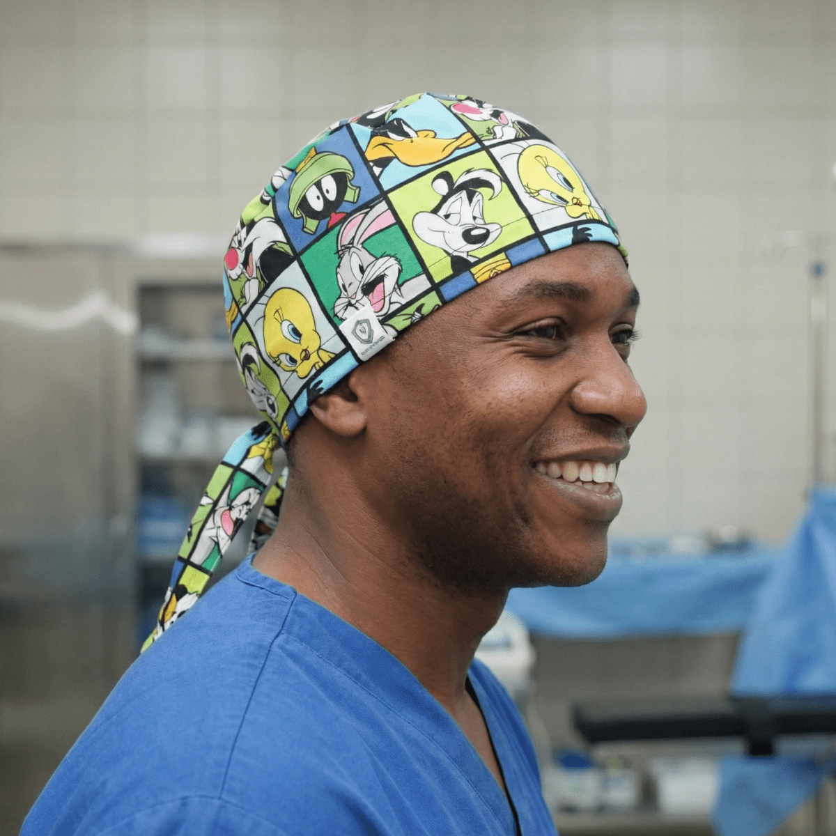 Looney Tunes cartoon characters grid pattern scrub cap with colourful comic squares