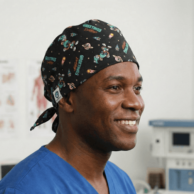 Black scrub cap with colourful Looney Tunes cartoon characters and space theme pattern