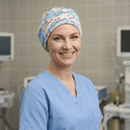 Healthcare worker wearing blue Simpsons titles pattern scrub cap, front view in medical setting