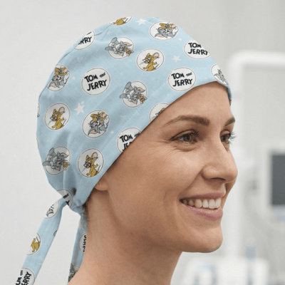 Tom and Jerry cartoon characters in circles on light blue scrub cap with ties