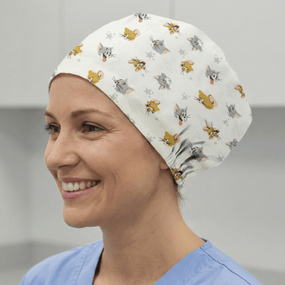 White scrub cap with yellow and grey Tom and Jerry cartoon character pattern