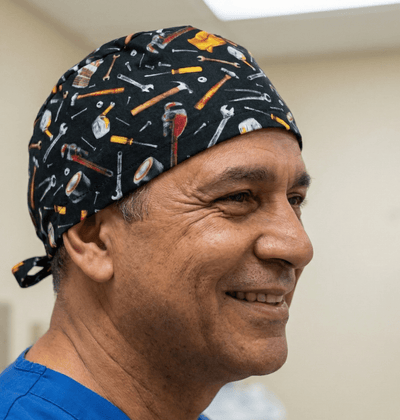 Black scrub cap with colourful tools pattern including hammers wrenches and screwdrivers