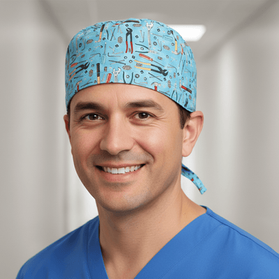 Light blue scrub cap with tools pattern including wrenches, hammers and pliers design