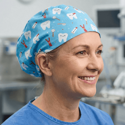 Turquoise blue scrub cap with cute cartoon tooth and toothbrush pattern for dental professionals