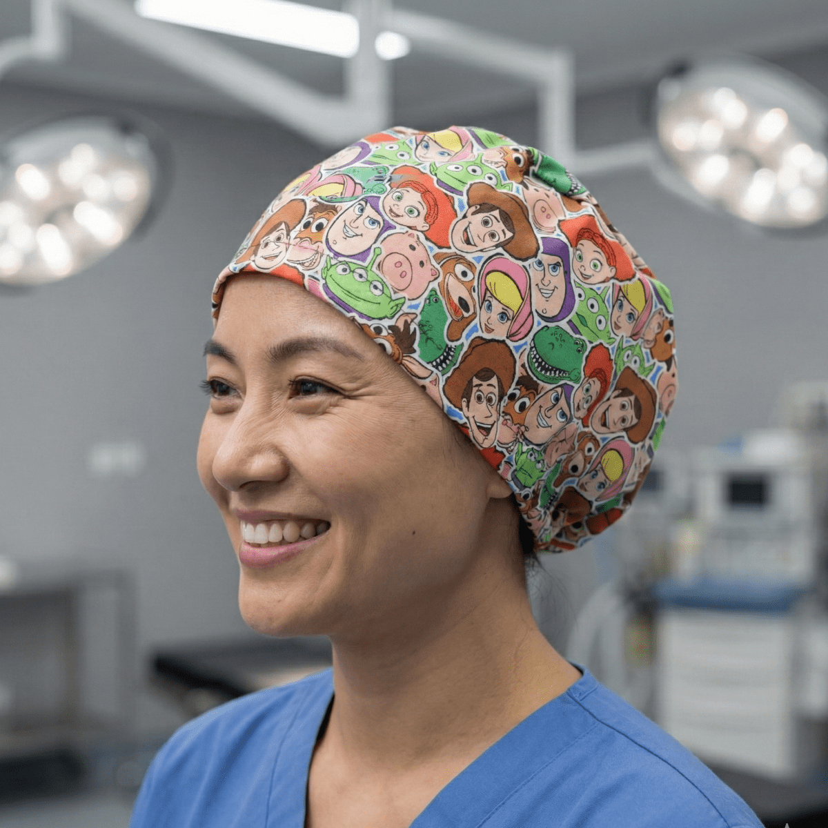 Colourful Toy Story character faces cartoon print scrub cap with bright multicoloured design