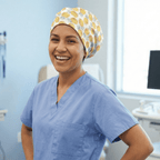 Healthcare worker wearing yellow pineapple pattern scrub cap, front view showing bright tropical design