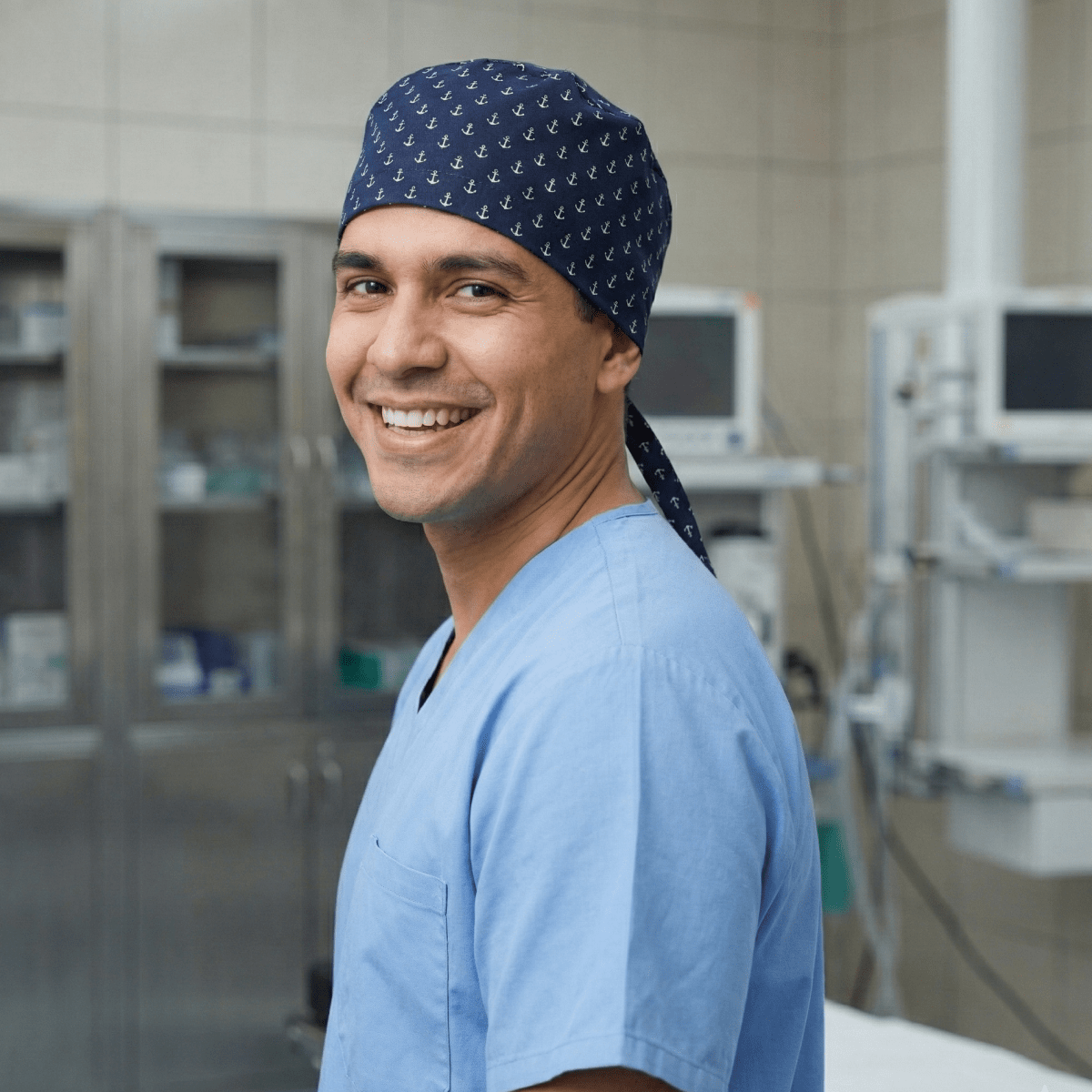 Healthcare professional wearing navy scrub cap with white star pattern, side profile view