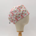 Side view of white custom scrub cap featuring pink unicorns and colorful floral prints. Handmade unicorn floral scrub cap by Medicus Caps in a bouffant style, suitable for medical professionals or long hair.