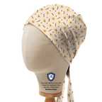 Side view of Winnie The Pooh repeat pattern scrub cap in cream with yellow characters