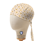 Side profile view of Winnie The Pooh pattern scrub cap in cream with cartoon bears and text