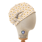Side view of Winnie the Pooh repeat pattern scrub cap in cream yellow on mannequin head