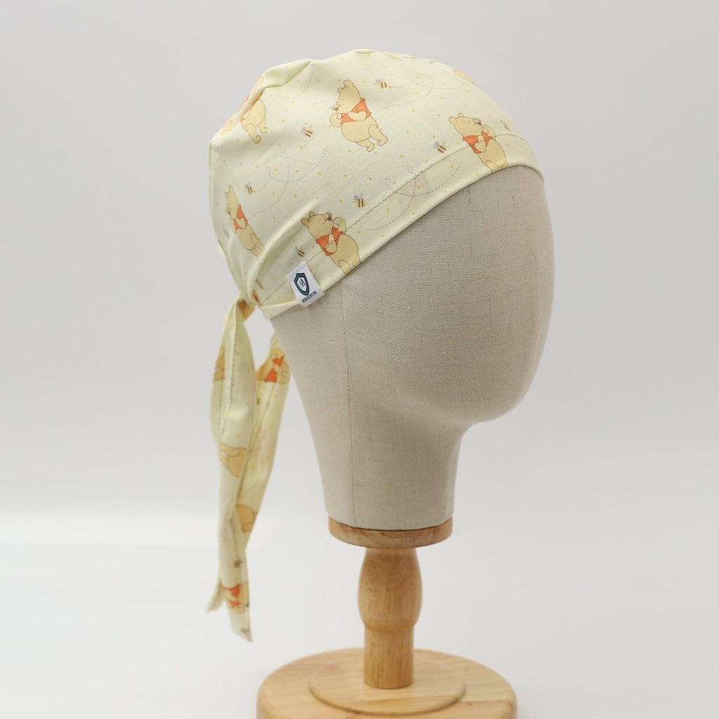 Side view of yellow custom scrub cap featuring animal print pattern, handmade by Medicus Caps