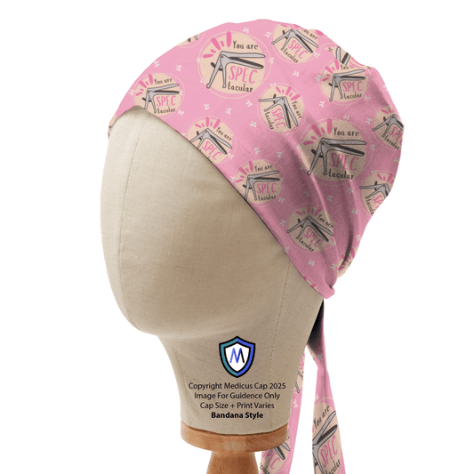 Pink Medicus Scrub Cap in bandana style with "You Are SPECtacular" design, featuring speculums and text, displayed on a mannequin head.