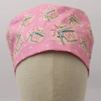 Pink scrub cap with eyeglasses and "You are SPECtacular" text pattern shown on mannequin head