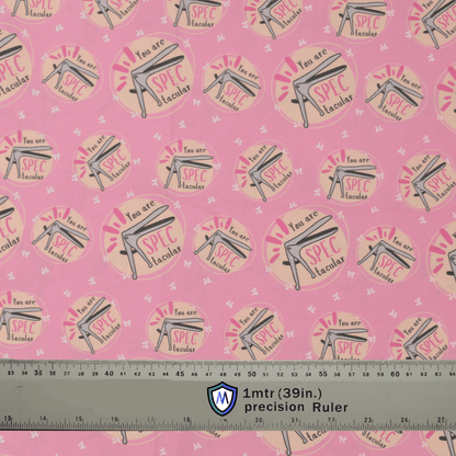 Pink Medicus Scrub Caps fabric with a speculum pattern and "You are SPECtacular" text, alongside a ruler for scale.