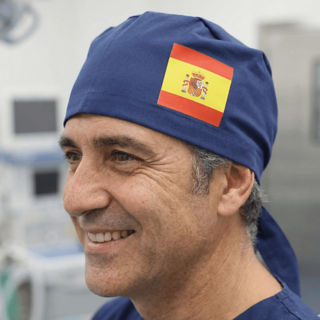 Side profile view of navy blue scrub cap with Spanish flag vinyl transfer patch