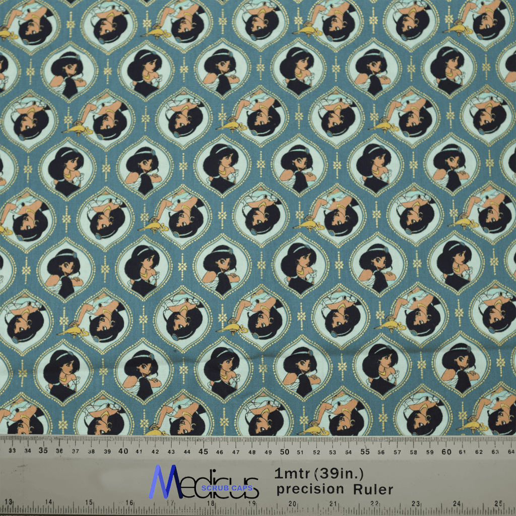 The Aladdin Jasmine Heads Theatre Cap by Medicus Scrub Caps showcases stylized portraits of a character like Jasmine in various poses. The teal and blue design, featuring decorative elements, is ideal for healthcare professionals. A ruler at the bottom provides measurements.
