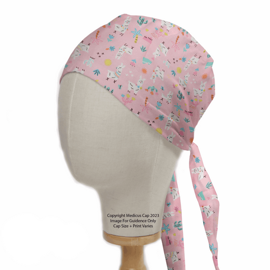 The Medicus Scrub Caps Alpaca / Llama Desert Pink Scrub Cap is shown on a mannequin head, featuring whimsical alpacas, colorful stars, and abstract shapes. Made from 100% hypoallergenic cotton, this eco-friendly cap ties at the back and offers playful patterns for a cheerful look.