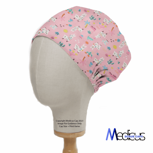 A mannequin head displays the Medicus Scrub Caps eco-friendly Alpaca / Llama Desert Pink Scrub Cap, crafted from hypoallergenic 100% cotton and featuring a playful alpaca and desert theme, set against a simple white background for charm and sustainability.