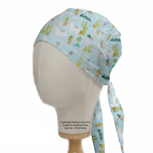 The Alpaca Mountain Blue Theatre Cap by Medicus Scrub Caps is modeled on a mannequin head, showcasing a light blue scrub cap with a playful llama and cactus pattern. It offers ultimate comfort and inclusive design, featuring long side ties for an adjustable fit.