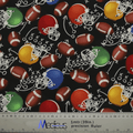 The American Football Theatre Cap by Medicus Scrub Caps features a lively pattern of colorful helmets with brown footballs on black, scattered with white play diagrams. A bottom ruler offers measurements in inches and meters, making it eco-friendly enthusiast ideal.