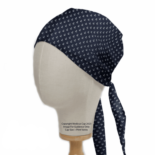 A mannequin head showcases an eco-friendly Anchors On Navy Scrub Cap by Medicus Scrub Caps, featuring a white anchor pattern. This hypoallergenic design ties at the back with long, elegantly hanging straps.