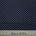 The Anchors On Navy Scrub Cap by Medicus Scrub Caps showcases a pattern of white anchors on dark blue fabric, designed to be eco-friendly and reusable. A ruler with centimeters and inches is visible below, partly revealing the Medicus label.