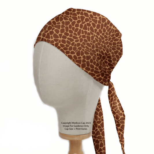 The mannequin head models Medicus Scrub Caps Animal Print Giraffe Scrub Cap in rich brown tones. Ideal for healthcare professionals, it ties at the back with a stylish untied portion hanging down, all set against a plain white backdrop to highlight its unique design.