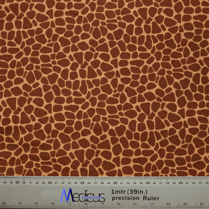 The Medicus Scrub Caps Animal Print Giraffe Scrub Cap, ideal for healthcare workers, showcases a chic giraffe pattern in brown and beige. It includes a ruler at the bottom for measurements in centimeters and inches, with blue and black text highlights.