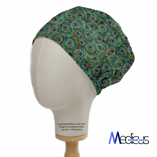 A mannequin head displays the Medicus Scrub Caps eco-friendly, reusable Animal Print Peacock Scrub Cap with a lively peacock feather pattern in green, blue, and brown on a white background. The brand logo is elegantly placed in the bottom right corner.