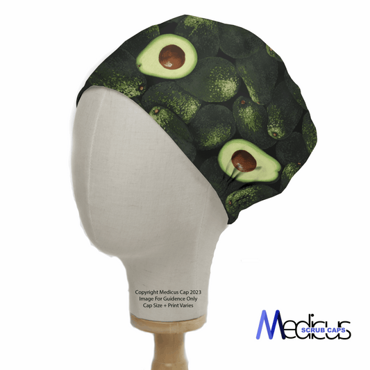 A mannequin head showcases the Medicus Scrub Caps brand Avocados Scrub Cap, featuring a pattern of whole and sliced avocados on a white background, combining healthcare professionalism with sustainable fashion.