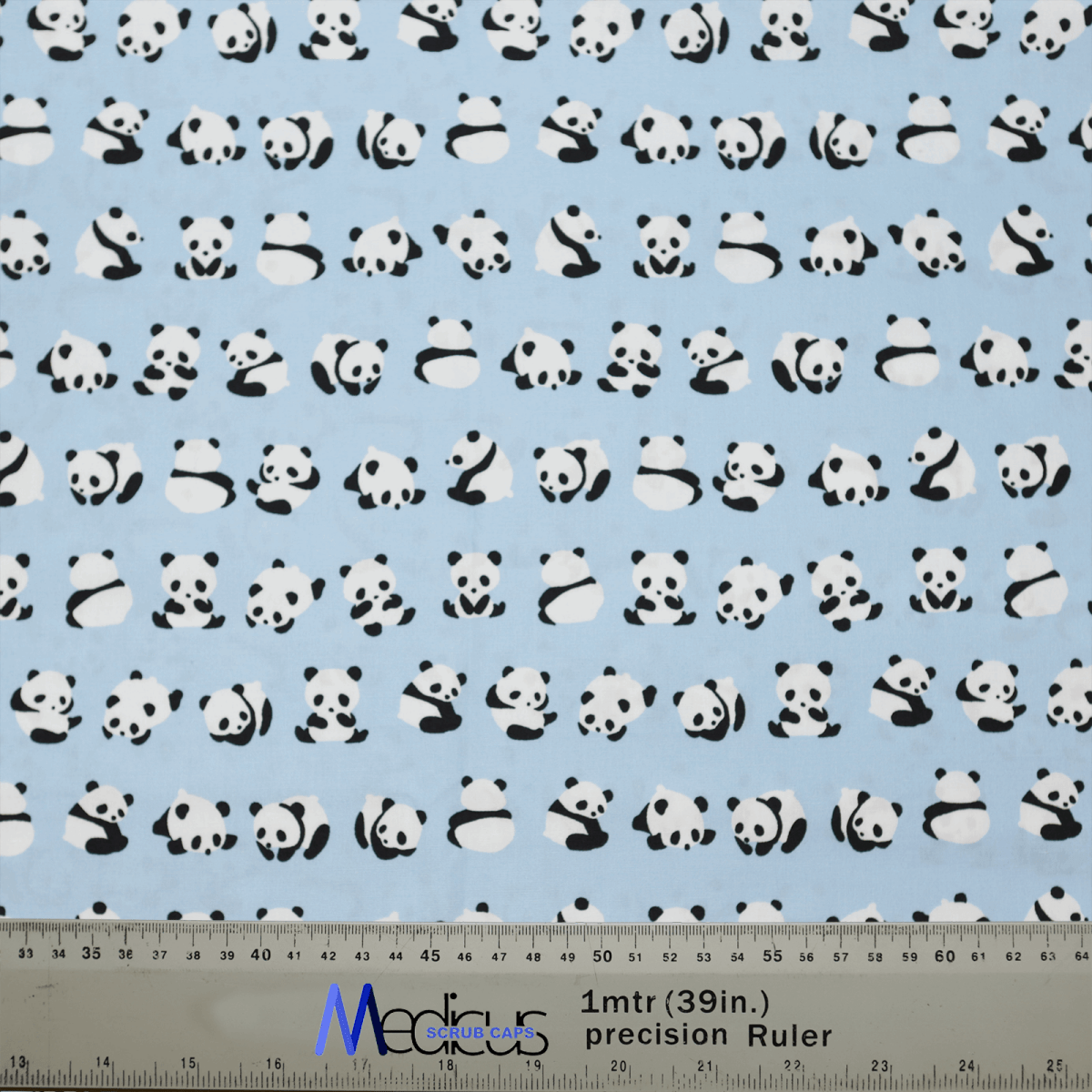 Medicus Scrub Caps presents the Baby Pandas On Blue Scrub Cap, an eco-friendly fabric adorned with cute cartoon pandas on a light blue background. A ruler at the bottom displays both centimeter and inch measurements, making it ideal for crafting a reusable scrub cap or baby panda-themed cap.