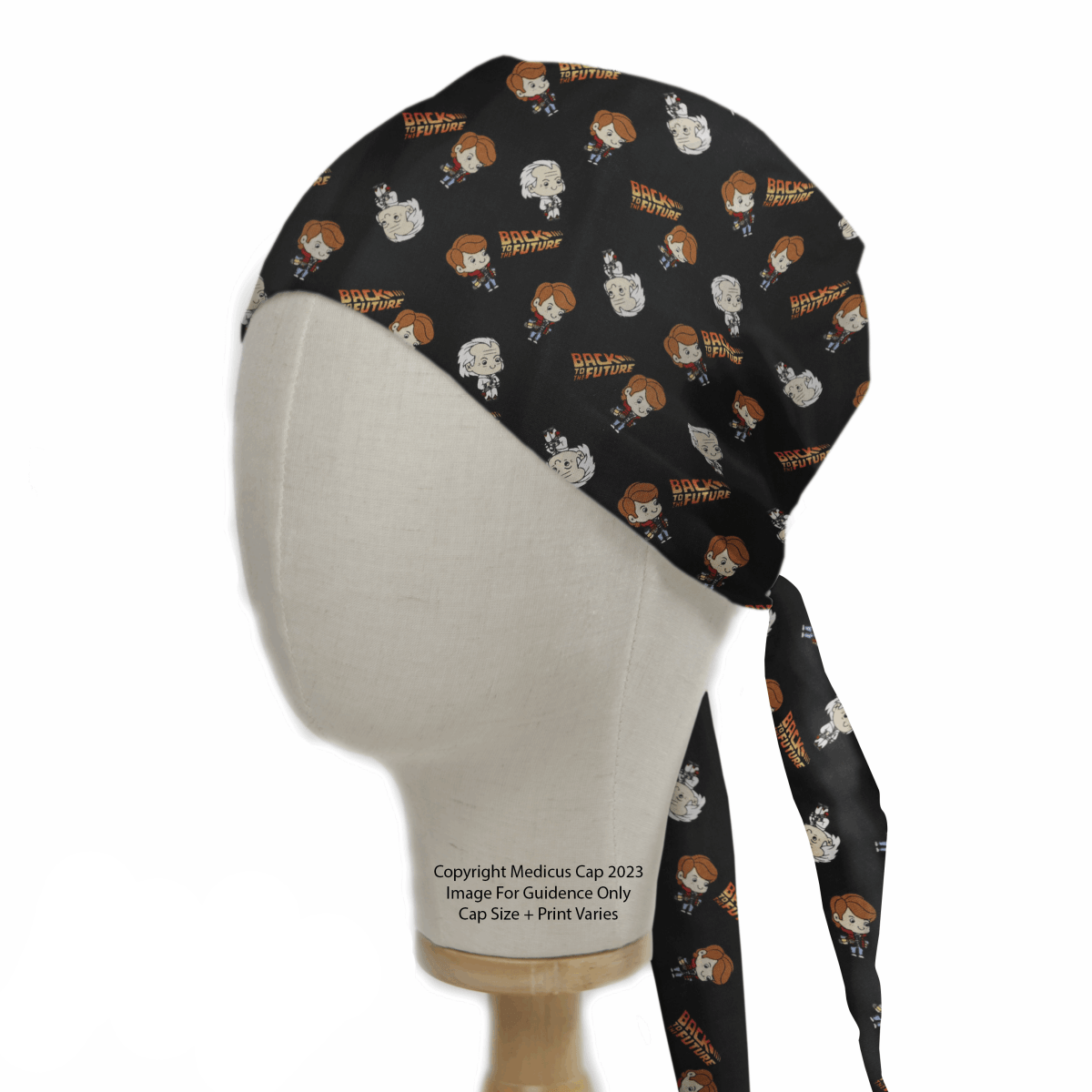 A mannequin head displays Medicus Scrub Caps Back To The Future Kawaii Scrub Cap in black, decorated with playful illustrations including a British Shorthair cat with glasses, one with orange hair, and the phrase “British Purrtish,” merging healthcare fashion and whimsy.