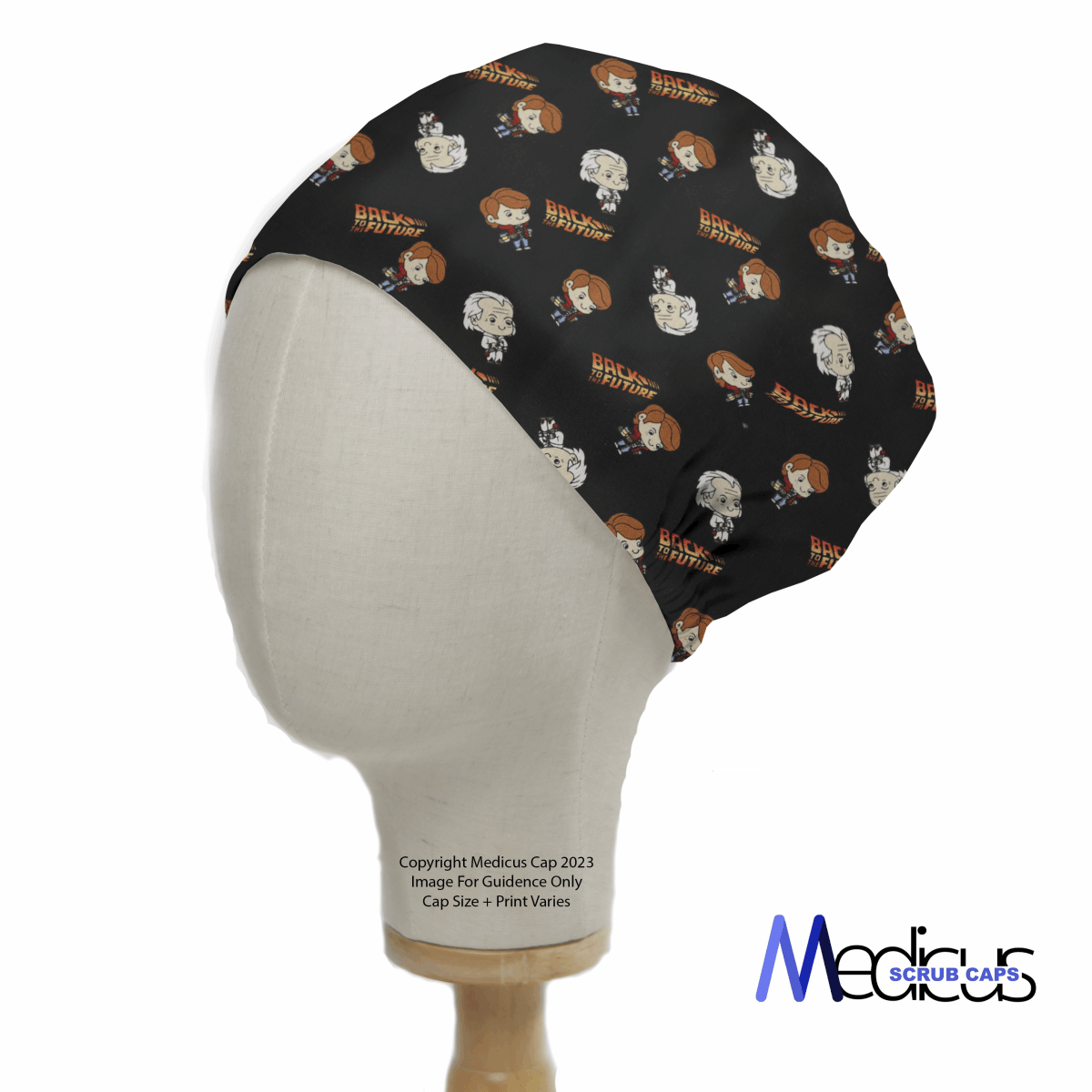 A mannequin head displays the Back To The Future Kawaii Scrub Cap by Medicus Scrub Caps, featuring black fabric with cartoon characters and the iconic movie logo, merging healthcare fashion and nostalgia.