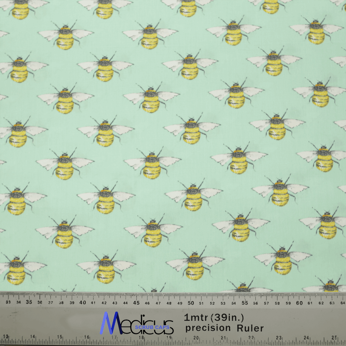 The Medicus Scrub Caps Bees On Teal Scrub Cap features a pale green background with yellow and black striped bees and white wings. A ruler at the bottom provides inch and centimeter measurements, blending style and precision for healthcare professionals.