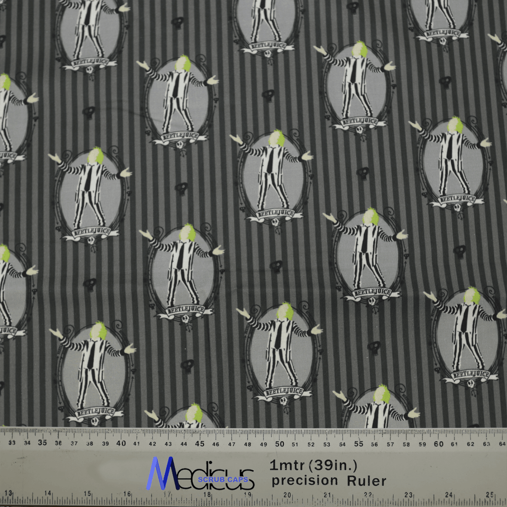 The Medicus Scrub Caps Beetlejuice Scrub Cap showcases a whimsical striped pattern featuring cartoon penguins in tuxedos on a black background. Their bright green eyes add charm, with the design repeating uniformly and a 39-inch ruler at the bottom of the image.