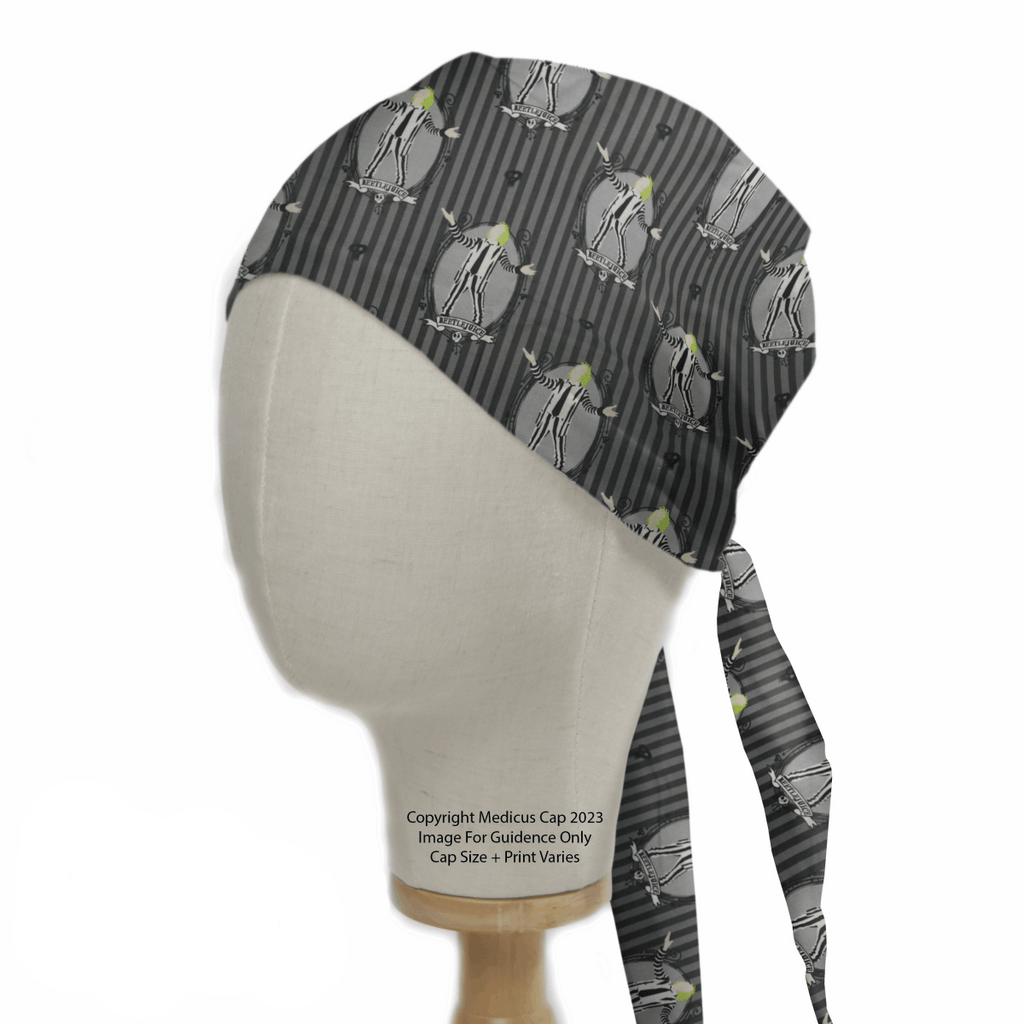 The Beetlejuice Scrub Cap by Medicus Scrub Caps showcases a whimsical penguin pattern with green accents. Reminiscent of Beetlejuices stripes, it features vertical lines and ties at the back for easy wear on a mannequin head.