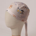 Bluey and Bingo Tossed on White fabric scrub cap in Bandana tie-back style: Bluey and Bingo tossed on white