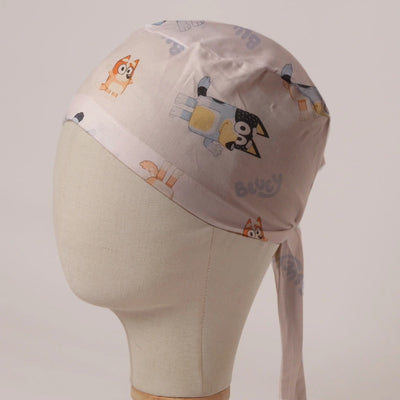 Bluey and Bingo Tossed on White fabric scrub cap in Bandana tie-back style: Bluey and Bingo tossed on white
