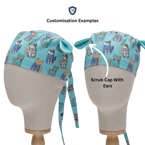 Two mannequin heads display healthcare attire, highlighting a teal scrub cap adorned with cats in medical outfits. One features added fabric ears for comfort and durability. Text says Customisation Examples with an arrow pointing to Classic Plain Imperial Purple Scrub Cap by Medicus Scrub Caps.