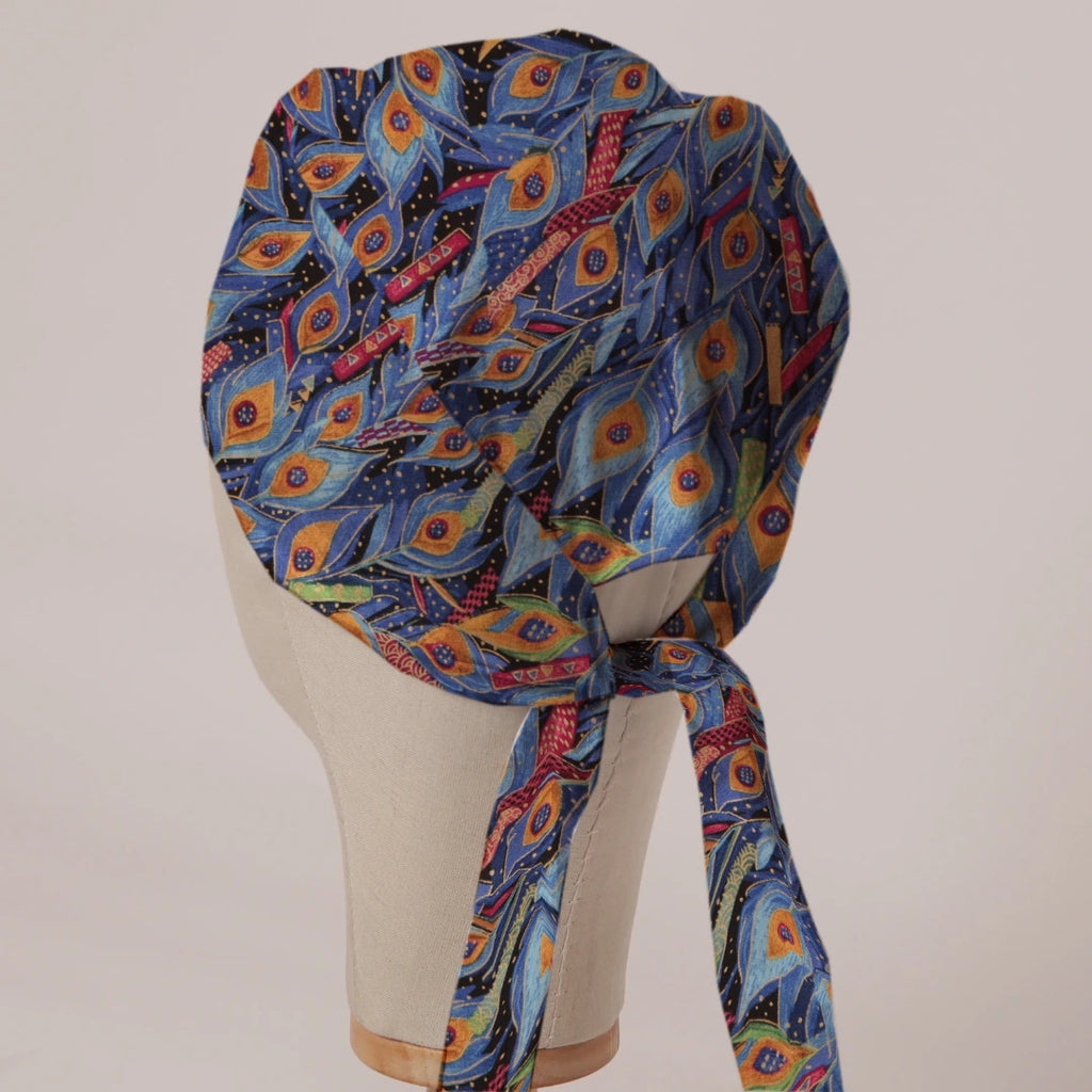 Colourful Peacock scrub cap in Bandana tie-back style on mannequin head, back view with ties