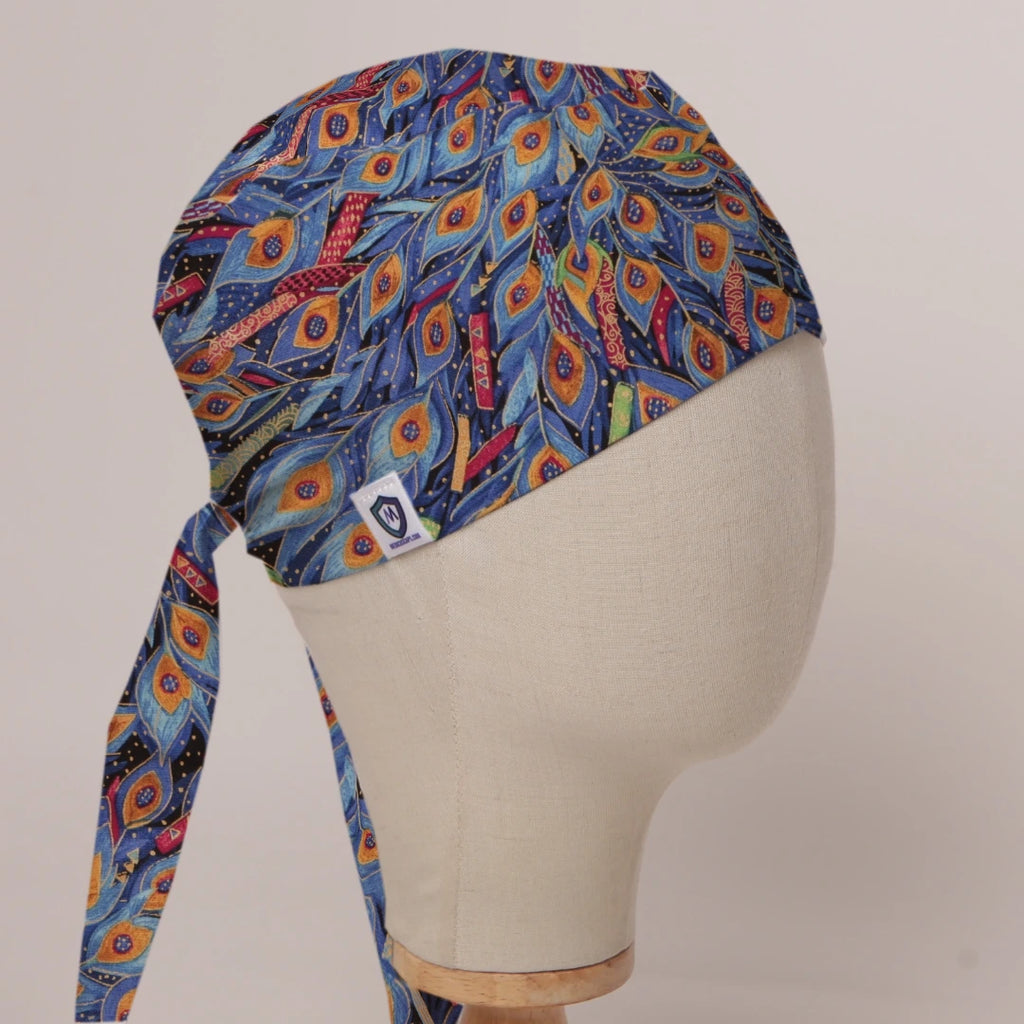 Colourful Peacock scrub cap in Bandana tie-back style on mannequin head, front right view with the Medicus label