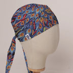 Colourful Peacock scrub cap in Bandana tie-back style on mannequin head, front right view with the Medicus label