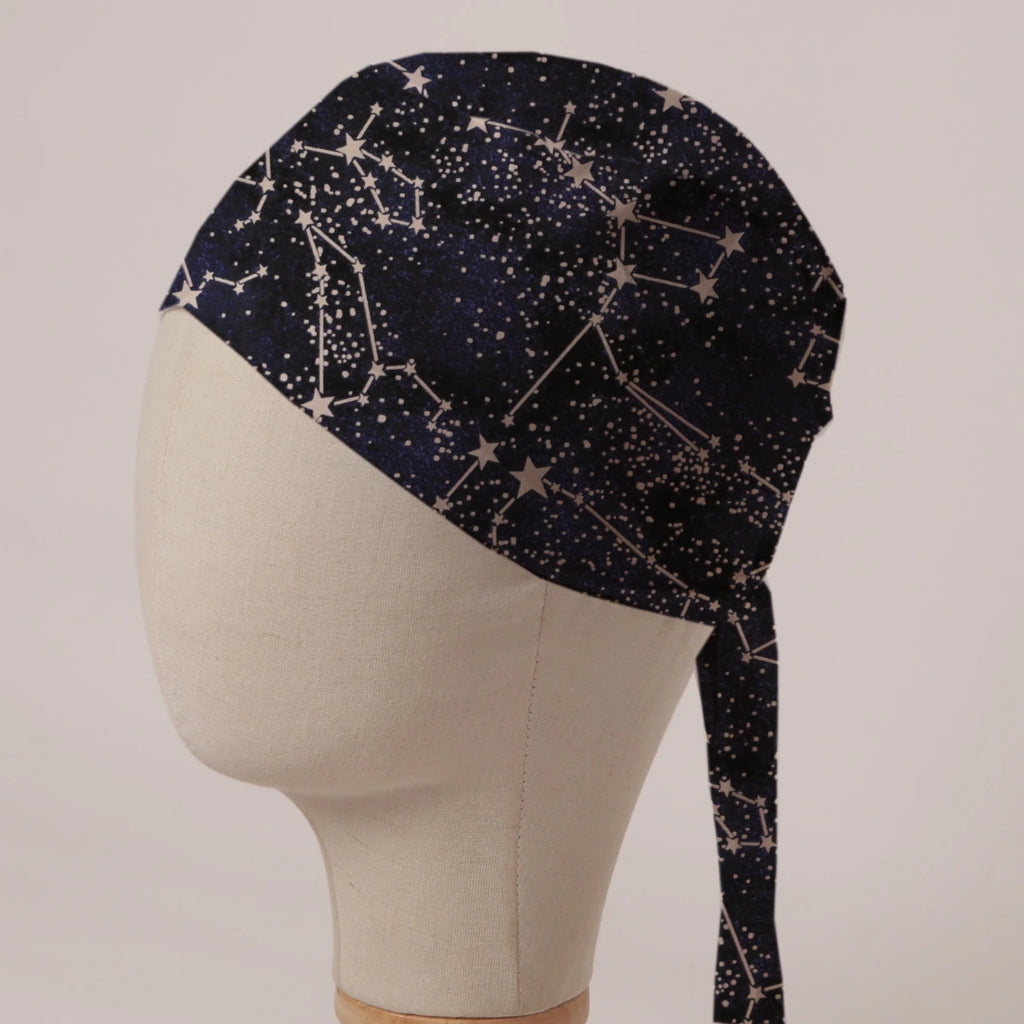 Constellations Stars scrub cap in Bandana tie-back style: cream constellations and stars on deep navy