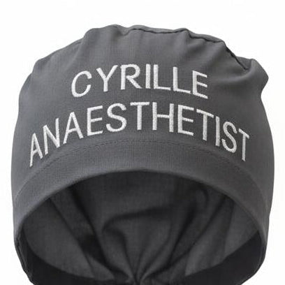 A scrub cap embroidered with a wearer's name and role