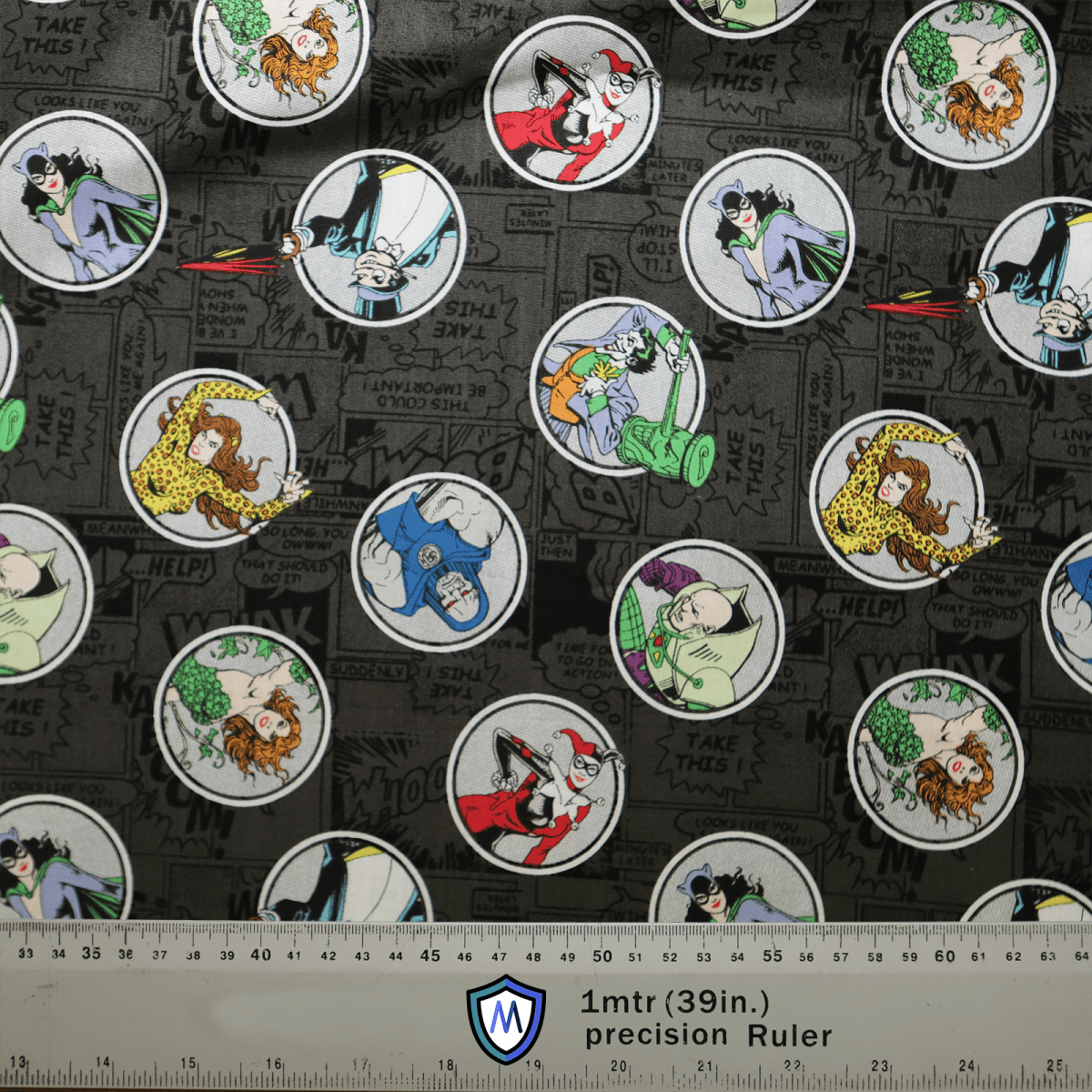 The Medicus Scrub Caps DC Comic Villains Circles fabric showcases comic-style prints of DC villains and cartoon characters in circular frames on gray, with text like HELP and TAKE THIS. Perfect for eco-friendly scrub caps, it measures 1 meter wide.