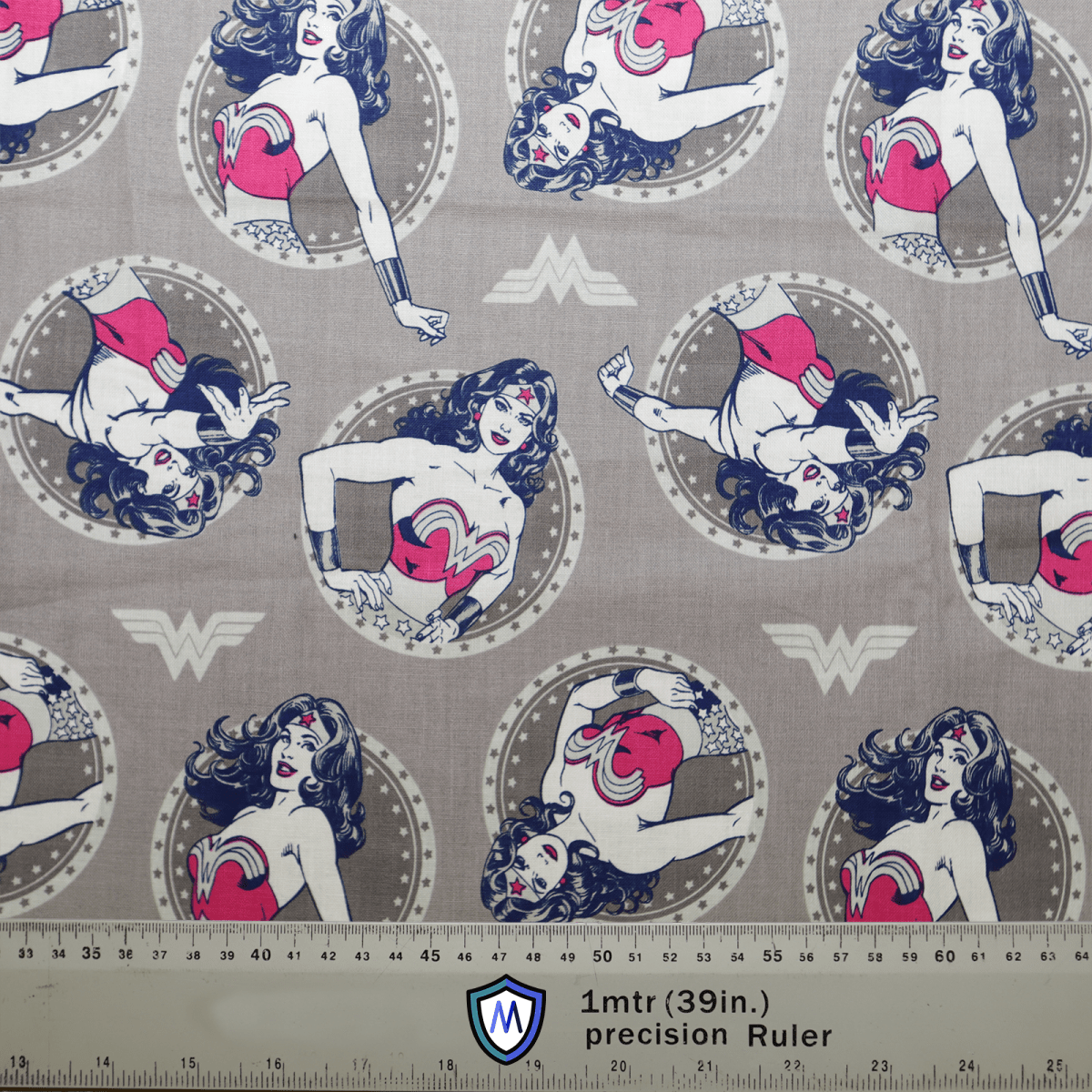 The Medicus Scrub Caps DC Comic Wonder Woman Grey Circles features a superheroine with long hair and a starred headpiece striking poses in circular frames. A 1-meter ruler at the bottom is ideal for designing your customizable scrub cap.