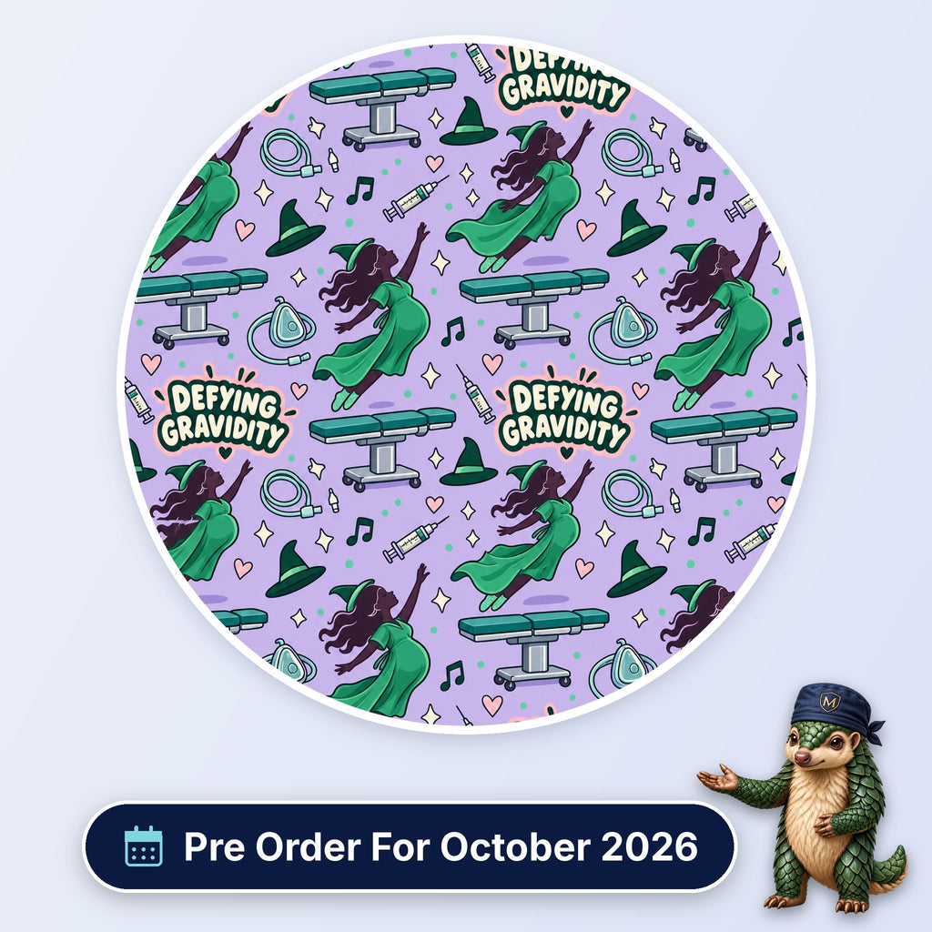 Defying Gravidity scrub cap print: a flying witch in green with operating tables, masks and syringes on lilac, with a Pre Order For October 2026 badge