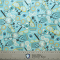 The Eye Doctor Mashup Scrub Cap by Medicus Scrub Caps features eye charts, glasses, eyes, and visual test symbols on a light blue background with an eco-friendly ruler at the bottom showing measurements in metric and inches.