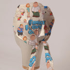 Family Guy Title and Cast fabric scrub cap in Bandana tie-back style on mannequin head, back view with ties